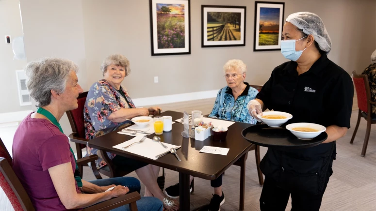 A group of elderly women enjoying soup at the Hamlets(red deer) residence