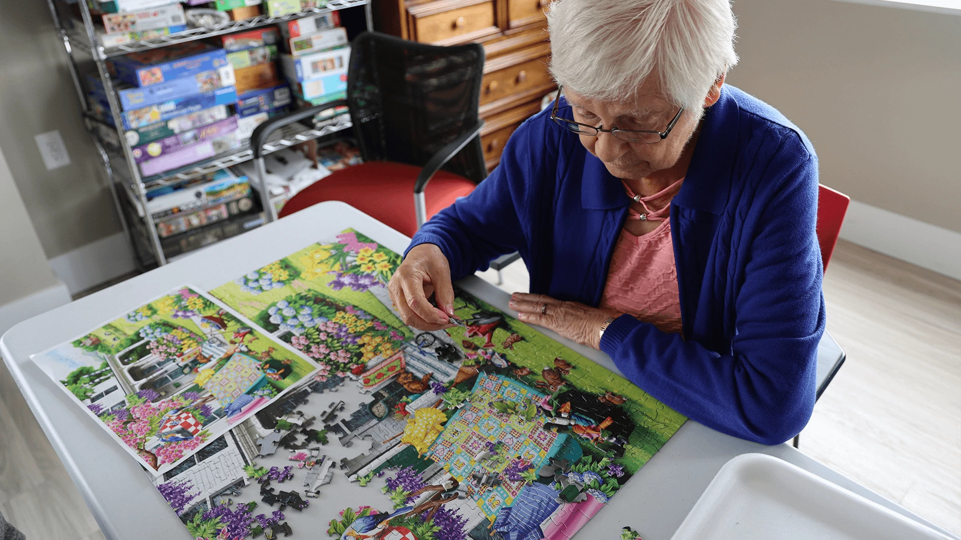 A senior woman finishing a puzzle